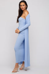 woman wearing a light blue ribbed two-piece set with a long cardigan and fitted skirt, paired with white strappy heels