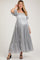 woman wearing a silver satin maternity maxi dress with puff sleeves and ruffled hem