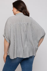 woman wearing a striped black and white maternity plus oversized blouse, showing a relaxed fit and short sleeves