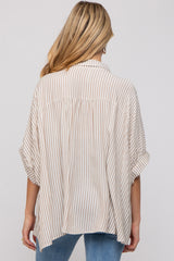 woman wearing a striped oversized maternity top with a relaxed fit and rolled sleeves, viewed from the back