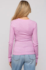 woman wearing a pink ribbed long sleeve maternity top, view from the back