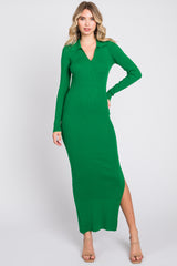woman wearing a green ribbed maxi dress with a v-neck and long sleeves, posing with one hand on her hip