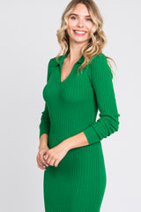 woman wearing a ribbed green long sleeve dress with a v-neck collar and fitted silhouette