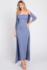 woman wearing a light blue ribbed off-the-shoulder maxi dress with a long cardigan and strappy sandals