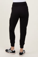 woman wearing black jogger pants with a relaxed fit and cropped cuffs, view from the back