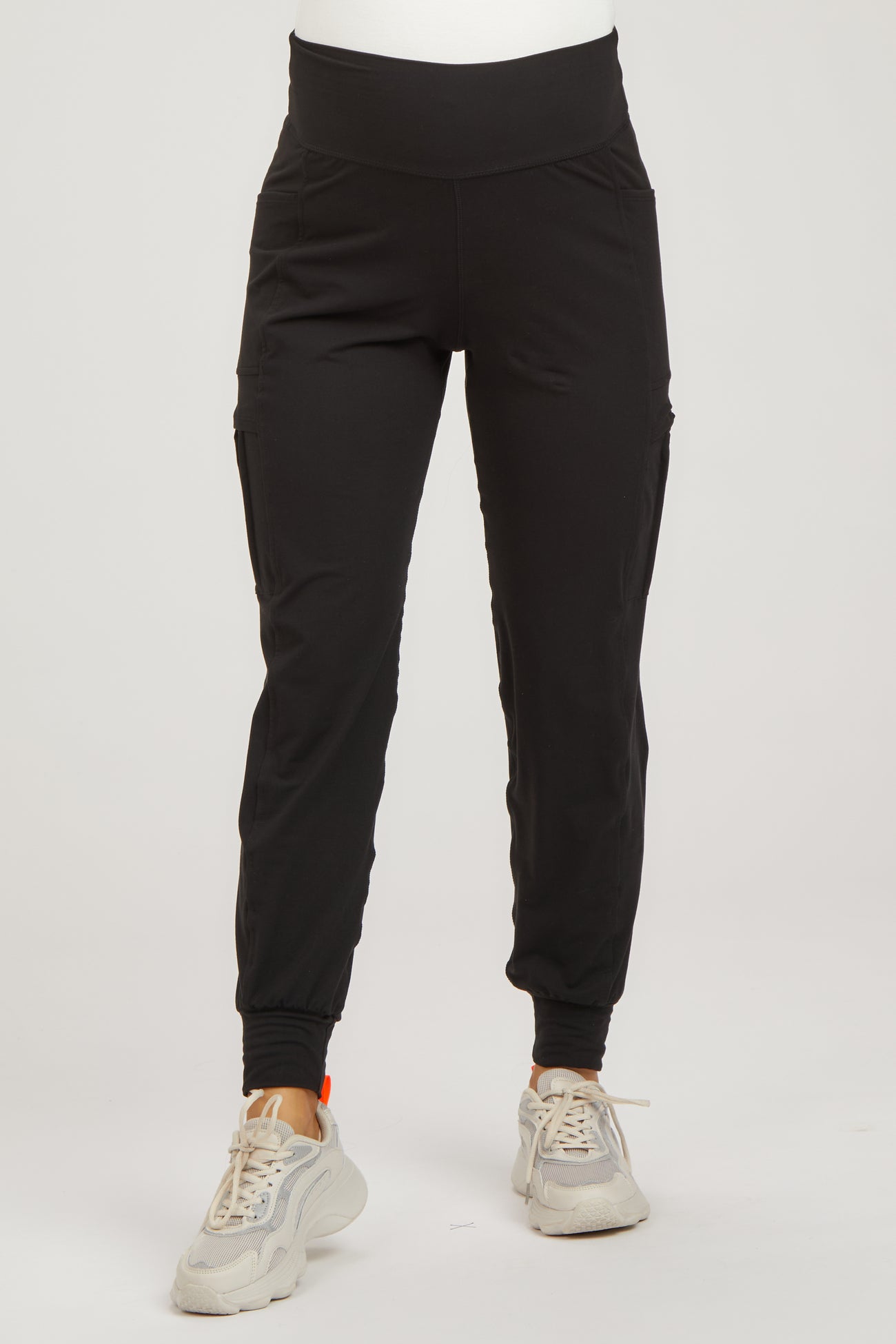 woman wearing black maternity jogger pants with side pockets and a stretchy waistband
