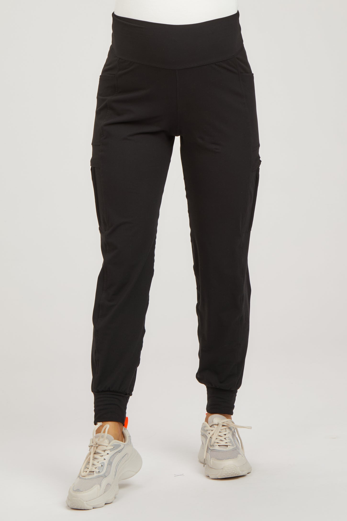 woman wearing black maternity jogger pants with side pockets and a stretchy waistband