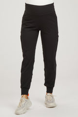 woman wearing black maternity jogger pants with side pockets and a stretchy waistband
