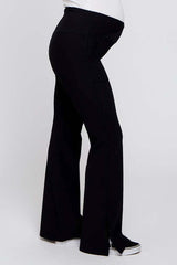 woman wearing black maternity pants with a flared leg and a stretchy waistband, showcasing a visible baby bump
