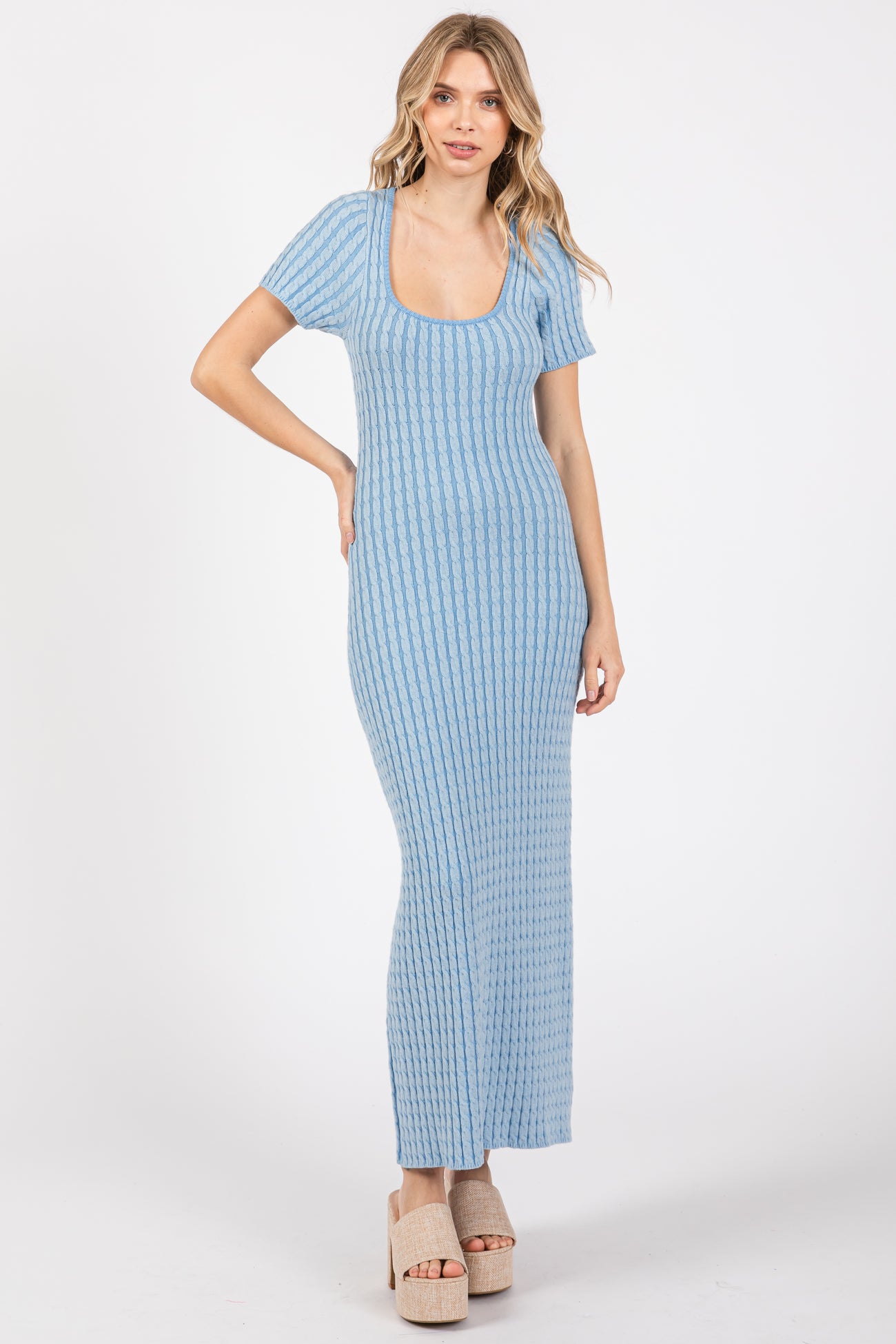 woman wearing a light blue ribbed maxi dress with short sleeves and a scoop neckline