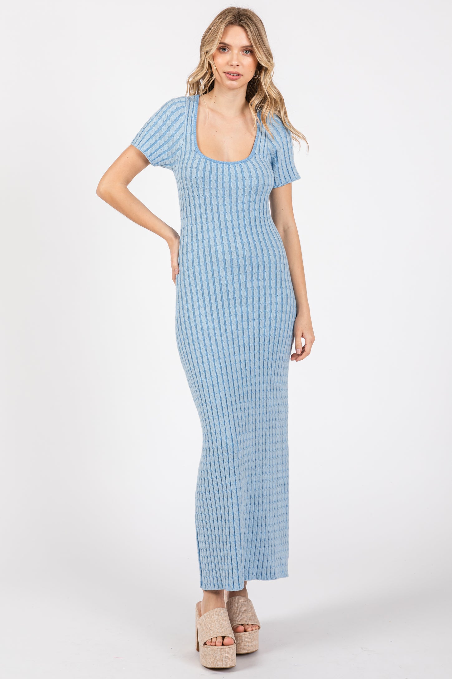 woman wearing a light blue ribbed maxi dress with short sleeves and a scoop neckline