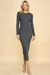 woman wearing a fitted long sleeve gray ribbed midi dress with a round neckline and side slit