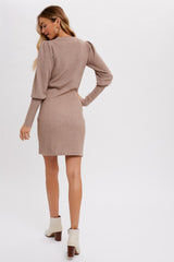 woman wearing a taupe long sleeve knit dress with puff sleeves and a fitted silhouette, viewed from the back