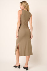 woman wearing a khaki sleeveless midi dress with side slits and a fitted silhouette