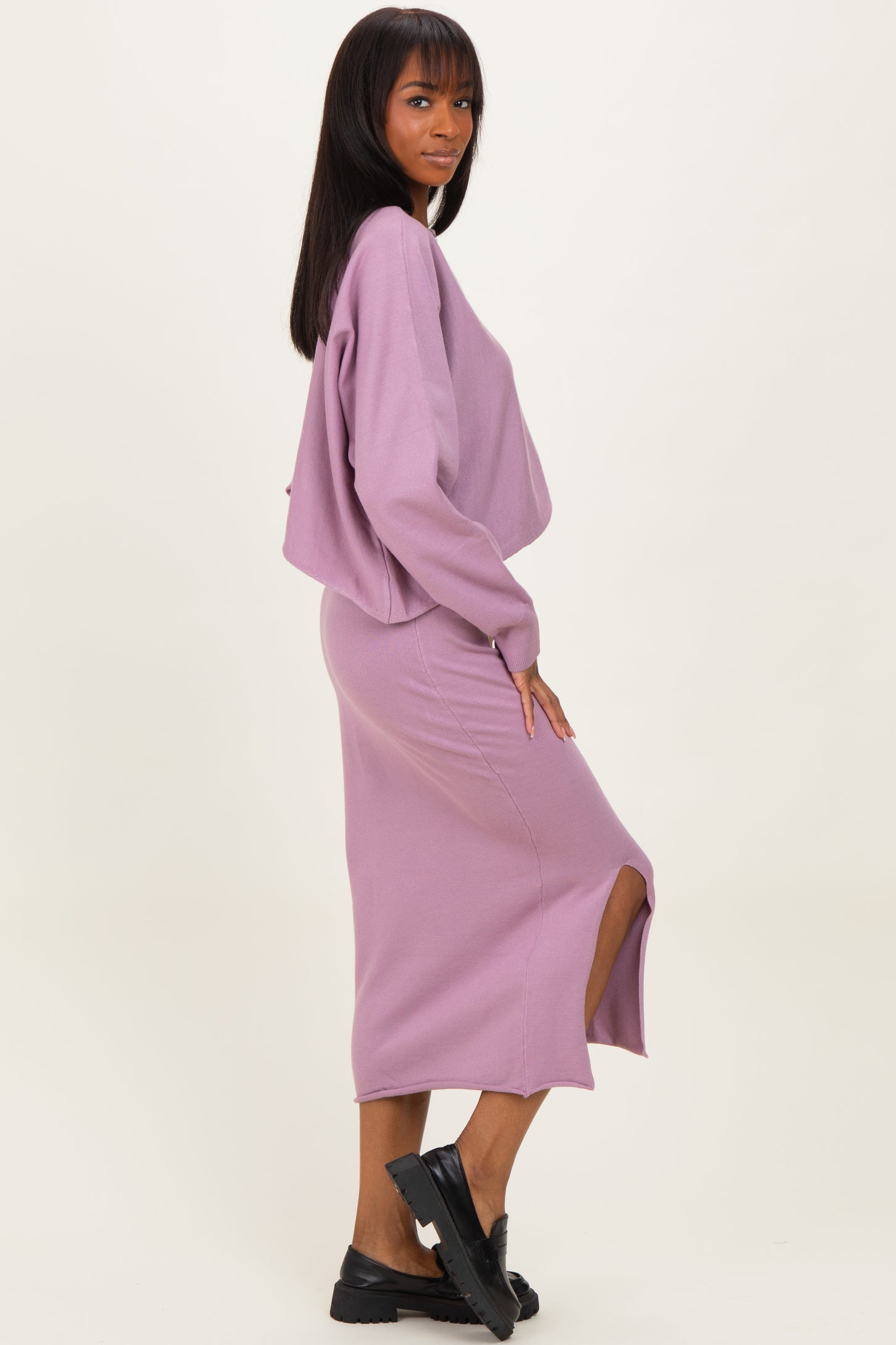 woman wearing a lavender cropped sweater and matching midi skirt with a side slit