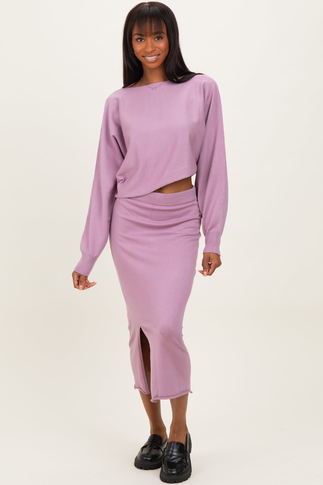 woman wearing a lavender cropped sweater and matching midi skirt with a front slit