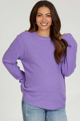 woman wearing a lavender knit maternity sweater with a relaxed fit and long sleeves