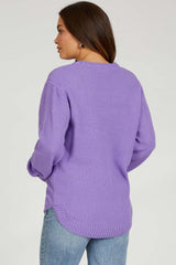woman wearing a purple textured maternity sweater with a relaxed fit and side slits, viewed from the back