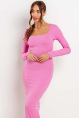 woman wearing a long sleeve pink ribbed maxi dress with a square neckline