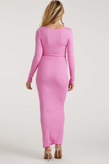 woman wearing a long pink ribbed maternity dress with a fitted silhouette, showing a baby bump from the back