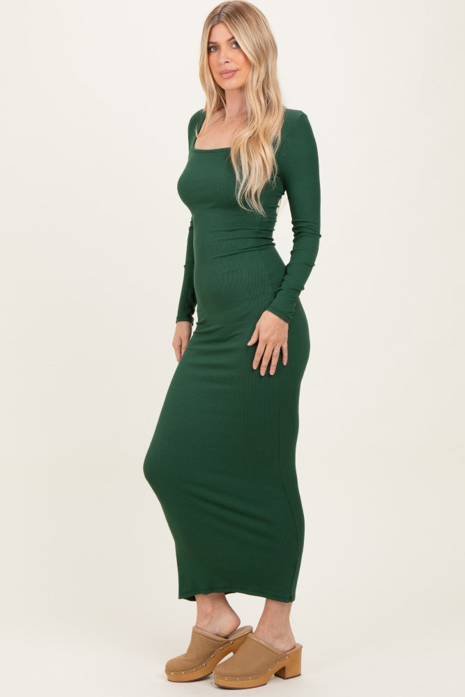 woman wearing a fitted dark green long sleeve maxi dress with a square neckline and side slit