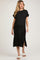 woman wearing a black maternity midi dress with short sleeves and side slits, showing her baby bump