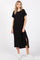 woman wearing a black oversized t-shirt dress with side slits and white sneakers