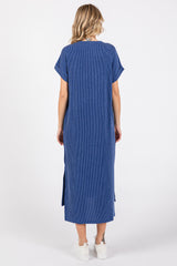 woman wearing a blue striped maxi dress with short sleeves and side slits, seen from the back