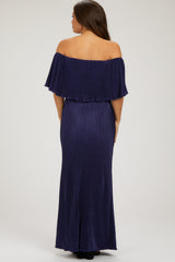 woman wearing a navy off-the-shoulder maternity gown with a flowy top and fitted skirt, showing a flattering silhouette