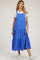 woman wearing a bright blue maternity dress with adjustable straps and tiered ruffle details over a white t-shirt