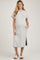 woman wearing a light gray ribbed maternity dress with side pockets and short sleeves, showcasing her baby bump