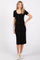 woman wearing a black ribbed midi dress with short sleeves and button detailing, paired with sneakers