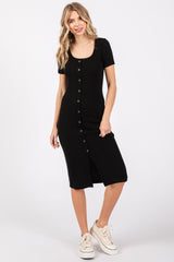 woman wearing a black ribbed button-front midi dress with short sleeves and a front slit, styled with white sneakers