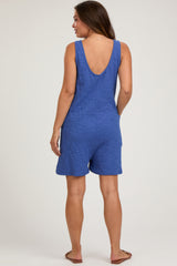 woman wearing a blue maternity romper with a low back and shorts style, displaying a relaxed fit