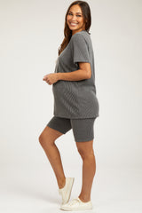woman wearing a gray ribbed maternity short set with a visible baby bump