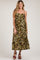 woman wearing a floral print brown maternity maxi dress with adjustable straps and a knot detail at the bust, featuring a baby bump