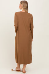 woman wearing a brown ribbed long sleeve maxi dress, viewed from the back