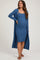 woman wearing a blue ribbed maternity dress and a matching long cardigan, showing her baby bump