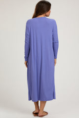 woman wearing a long sleeve purple maternity dress with a relaxed fit and side slits, showing a baby bump