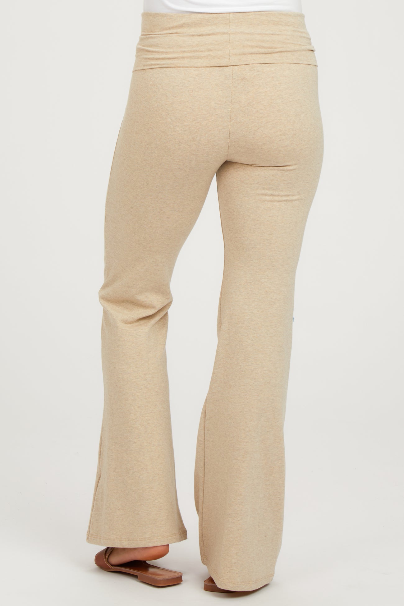 woman wearing beige maternity flare pants, shown from the back