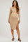 woman wearing a beige maternity ribbed two-piece outfit with a long sleeve crop top and a fitted midi skirt showing a baby bump