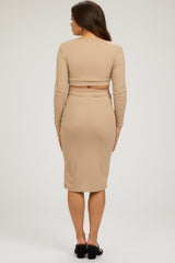 woman wearing a beige ribbed maternity two-piece outfit with a crop top and midi skirt, showing her back