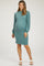 woman wearing a teal ribbed maternity dress with puff sleeves and showing her baby bump