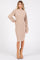 woman wearing a beige ribbed long sleeve sweater dress and tan ankle boots