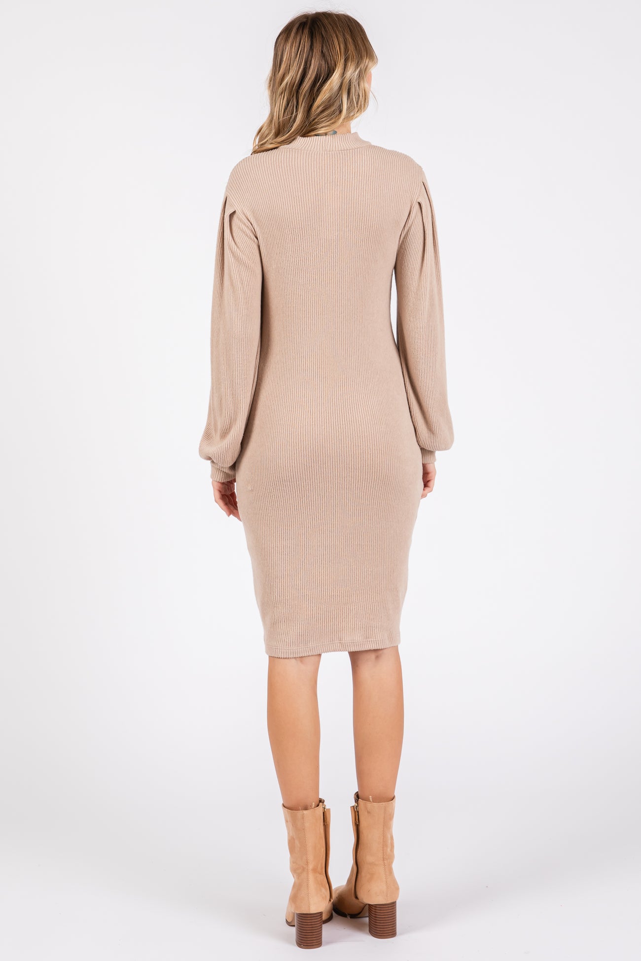 woman wearing a beige ribbed long sleeve dress with a fitted silhouette and balloon sleeves, view from the back