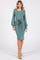 woman wearing a teal long sleeve midi dress with a tied waist and puff sleeves paired with beige ankle boots