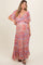 woman wearing a colorful patterned maternity maxi dress with flutter sleeves and a v-neckline, showcasing a baby bump