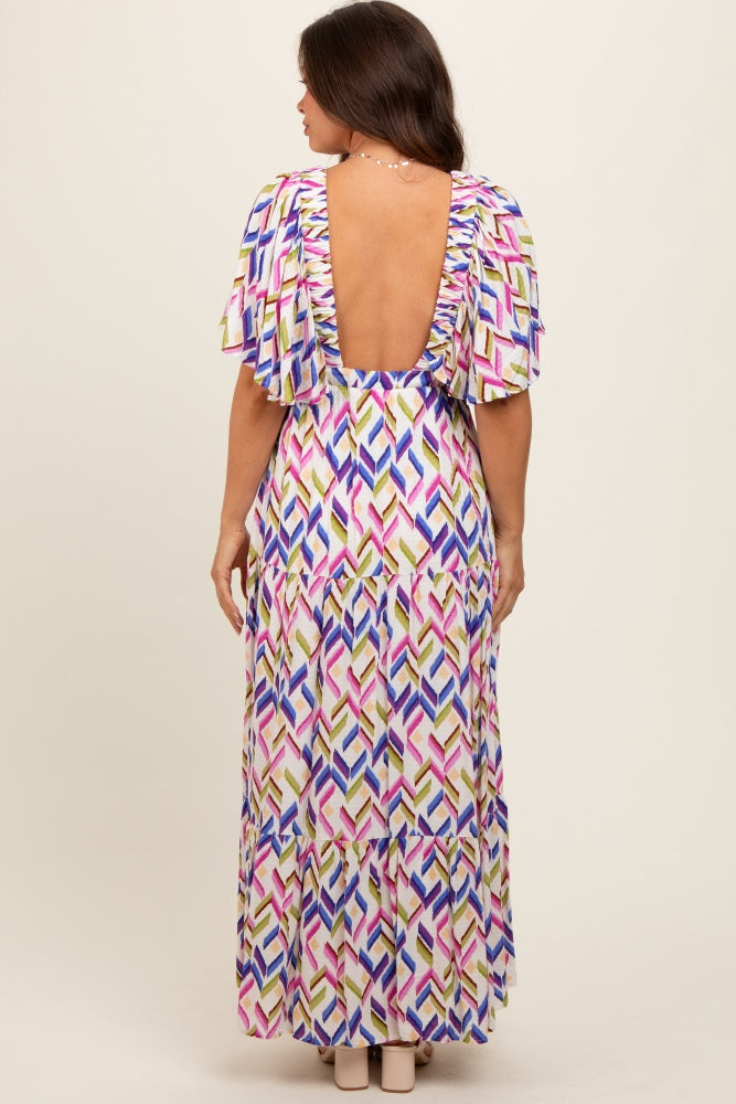 woman in a colorful patterned maternity dress with ruffled sleeves and a low back design