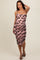 woman wearing a pink floral print ruched maternity dress, showing her baby bump, with spaghetti straps and knee-length hem