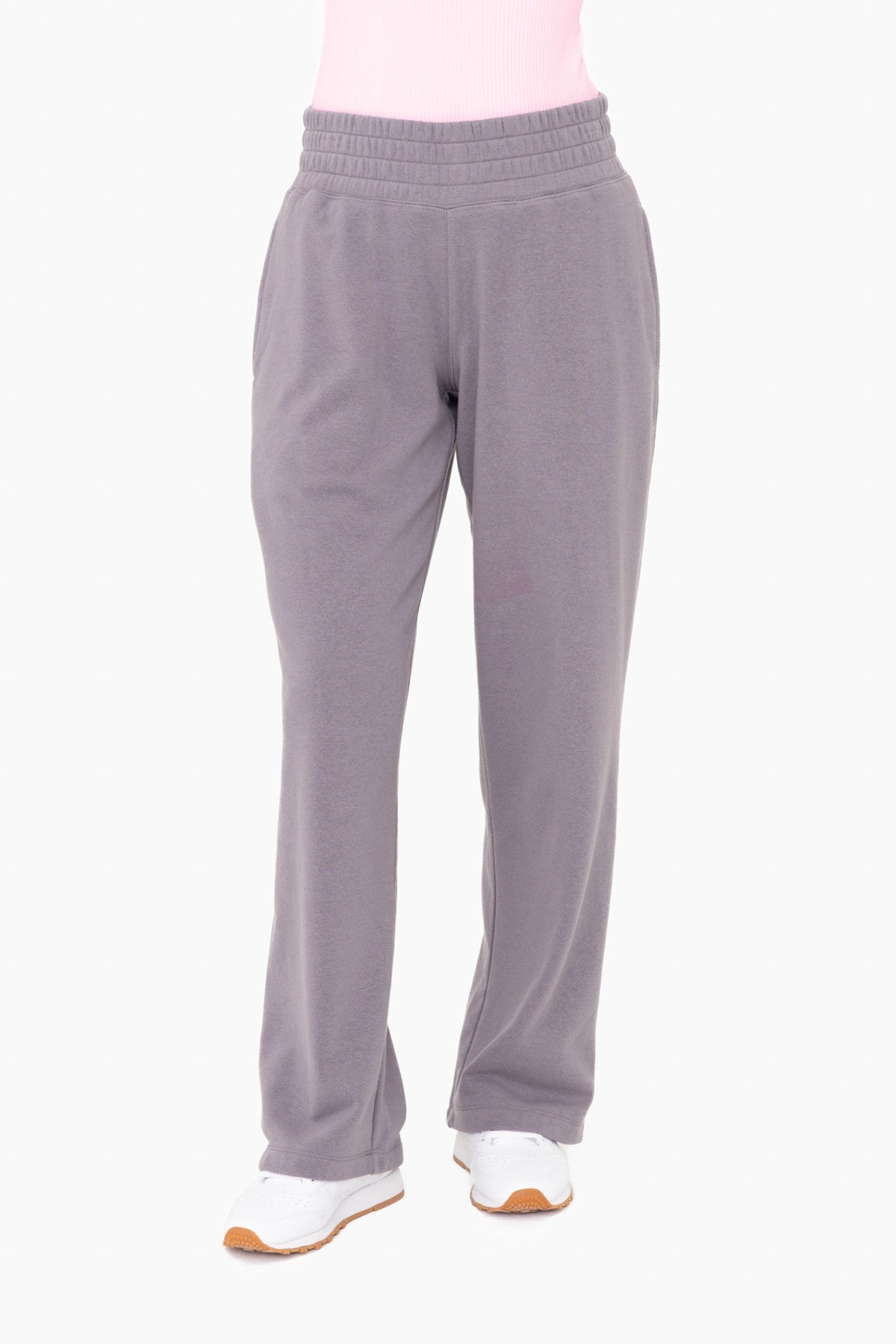 woman wearing gray fleece lounge pants with elastic waistband and side pockets